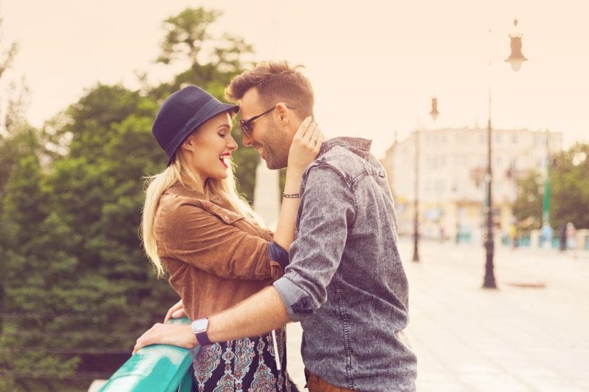 hip couple on bridge embracing