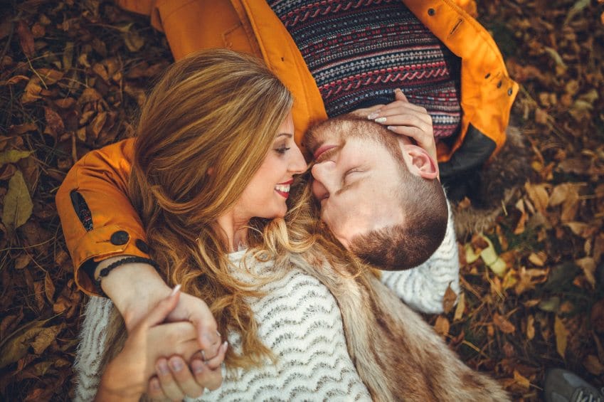 Happy couple embracing in leaves
