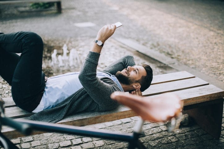 man laying down texting