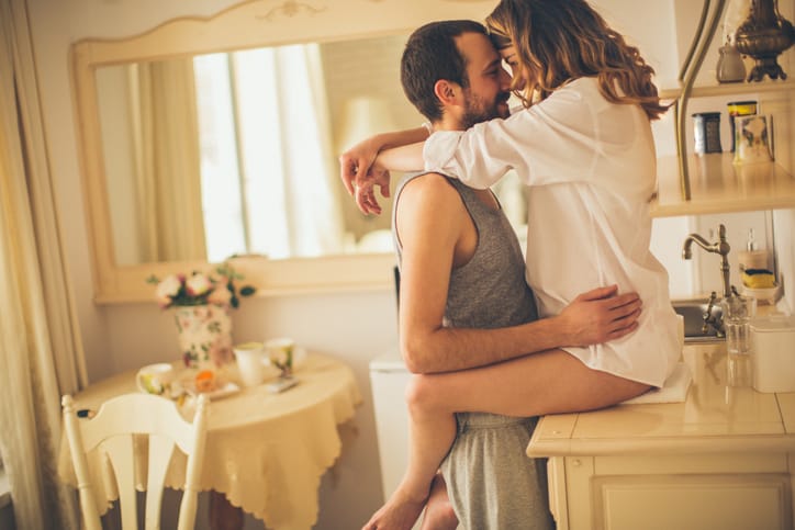 Loving couple is sharing their love and affection on Valentine's day in their rustic kitchen