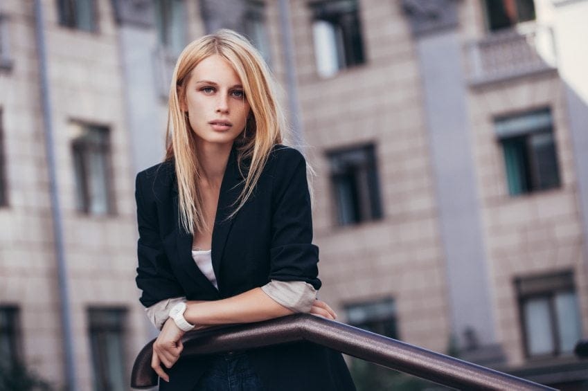 Blonde in suit jacket staring at camera