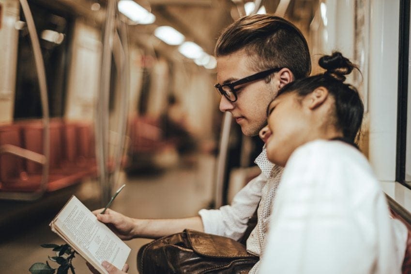 Couple on subway reading