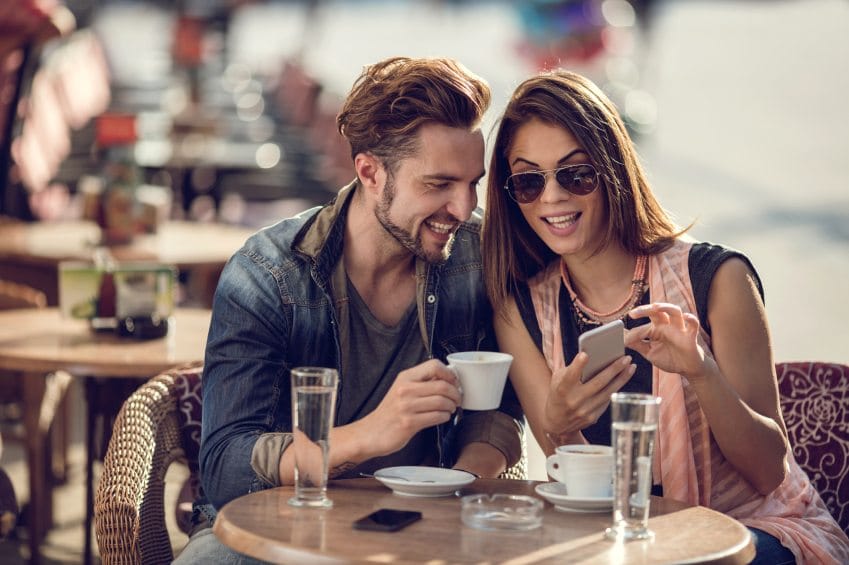 Smiling couple relaxing in a cafe