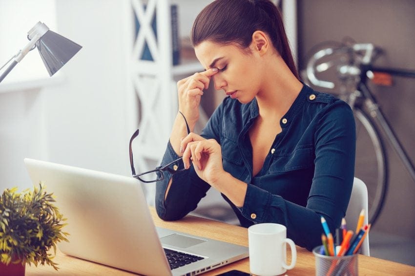Frustrated young woman keeping eyes closed