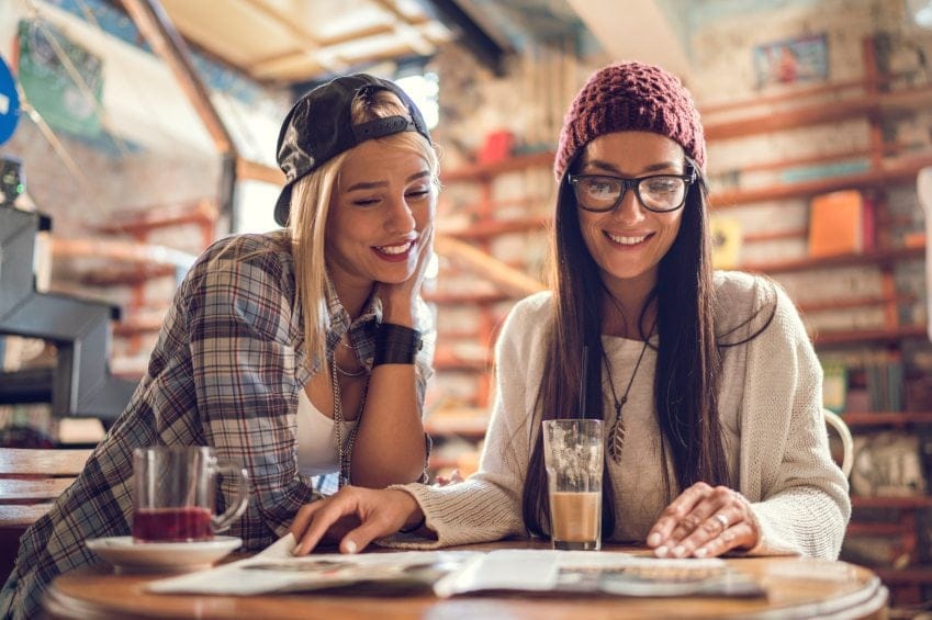 two women laughing reading