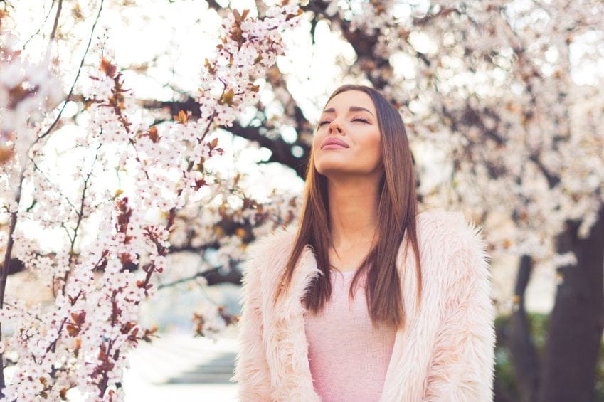 Girl standing under blossom tree