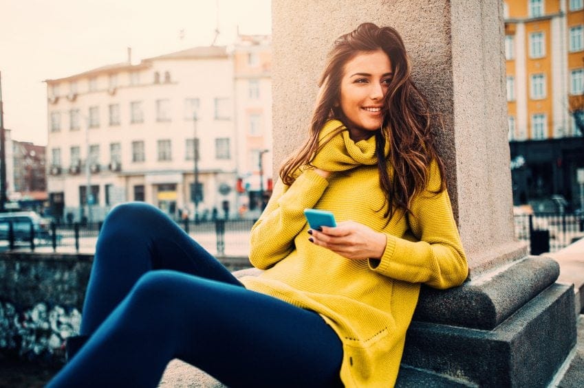 Brunette yellow sweater texting