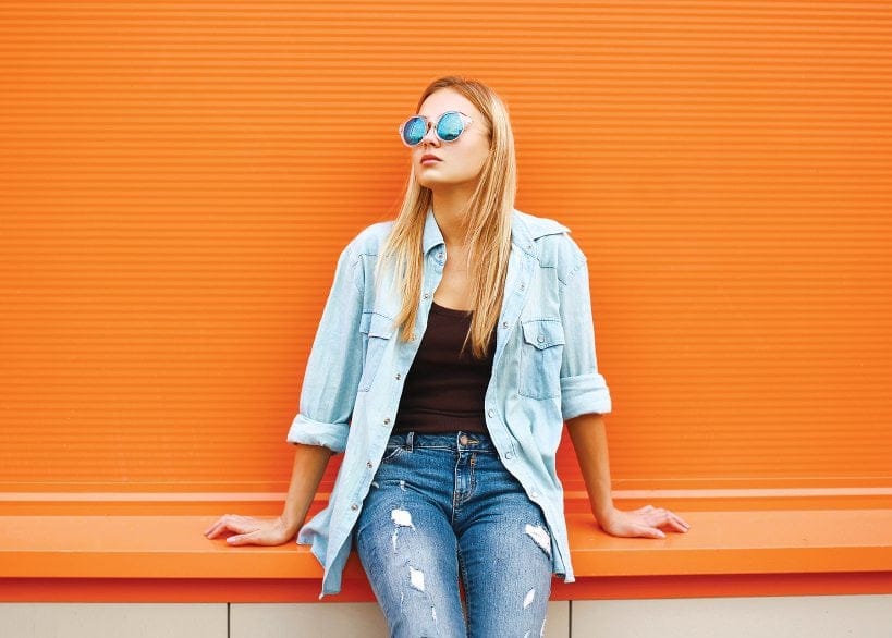 Blonde with orange wall behind