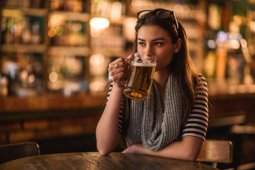 Pensive woman sitting in a bar