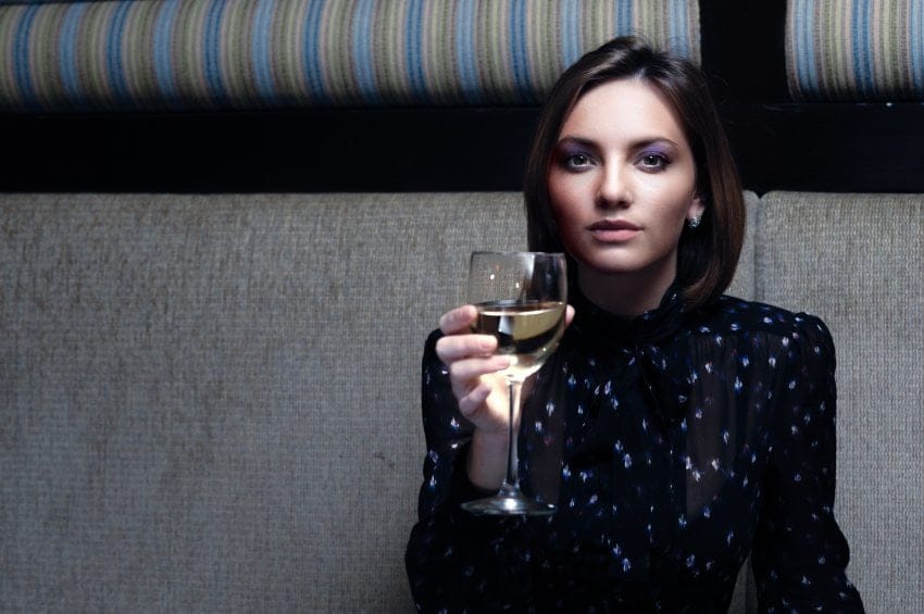 Woman drinking wine in a bar