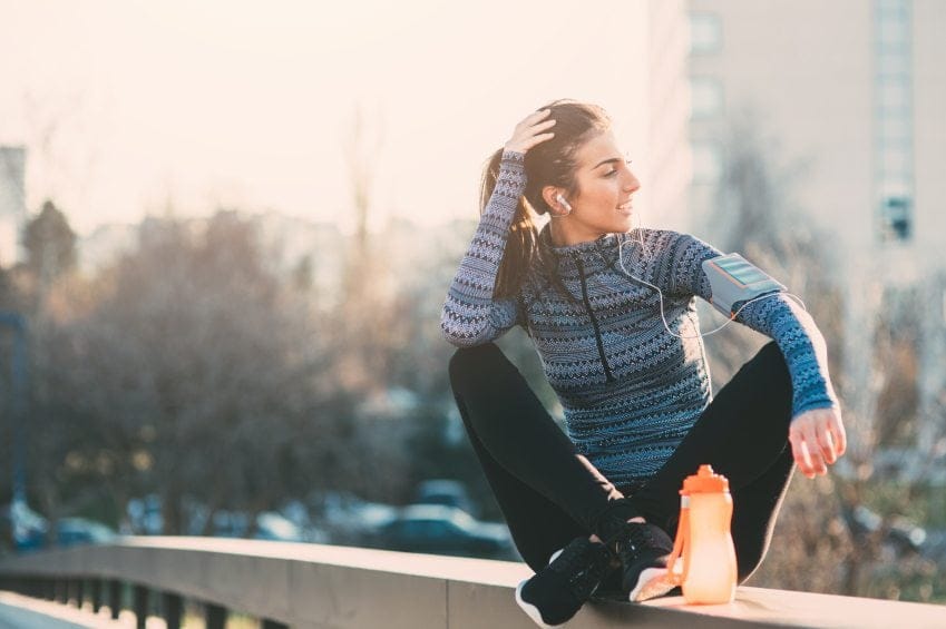 female sat on walk in running gear