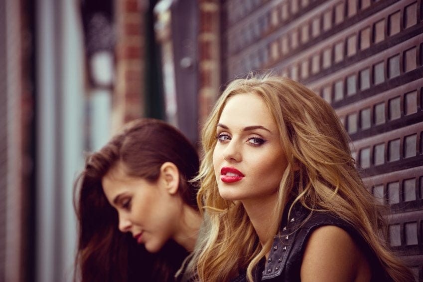 Two girls one looking at camera
