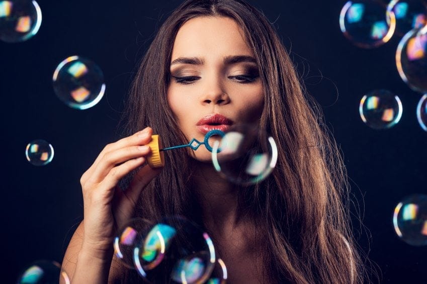 Brunette blowing bubbles