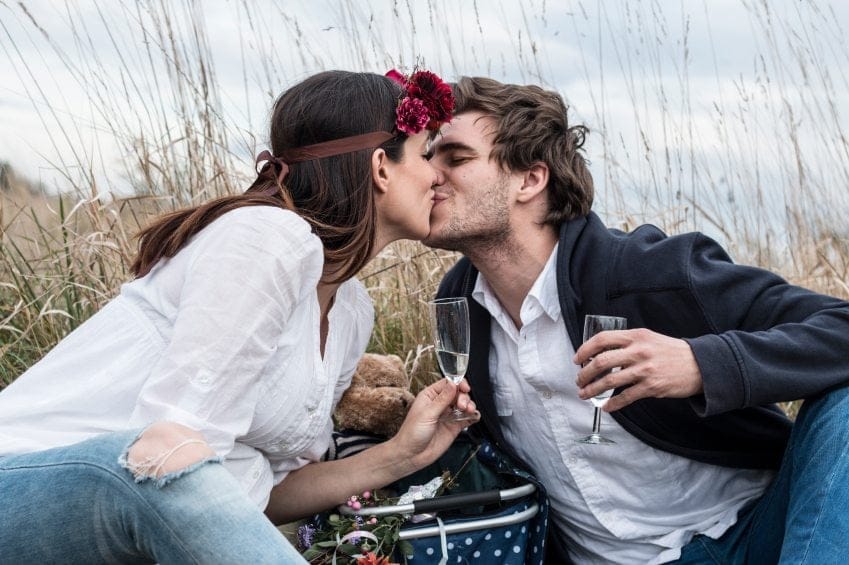 happy couple drinking picnic