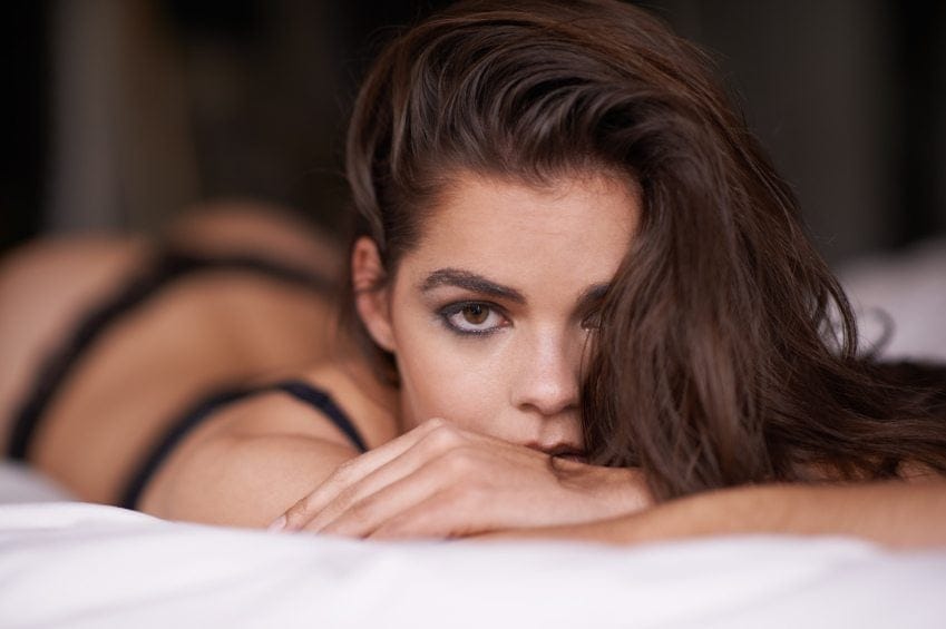 Woman in bed facing camera
