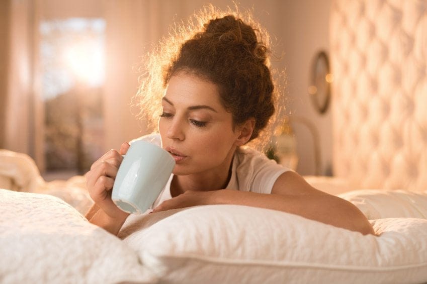 Young woman relaxing in bed