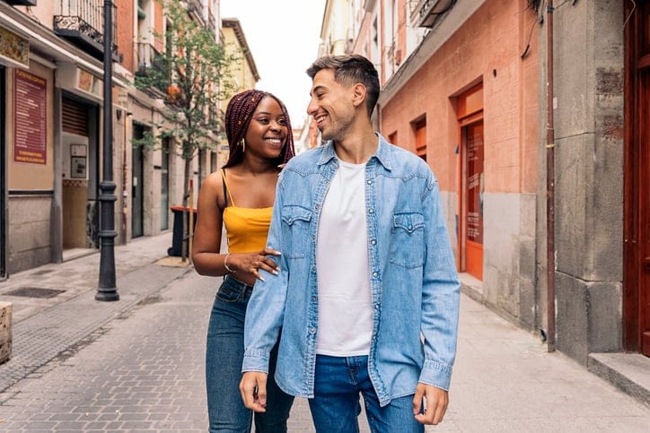 trendy couple walking city streets