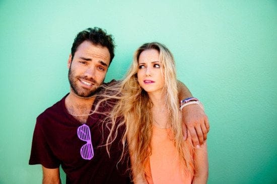 couple making funny faces green background