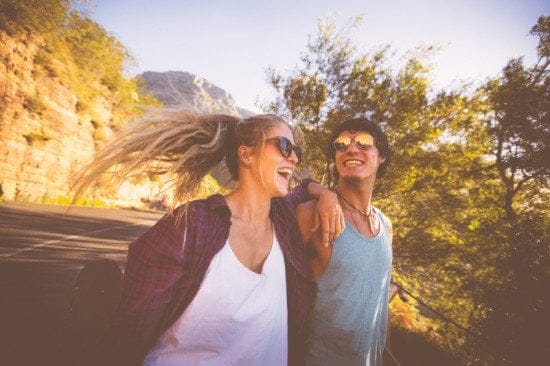 couple laughing outside on hike