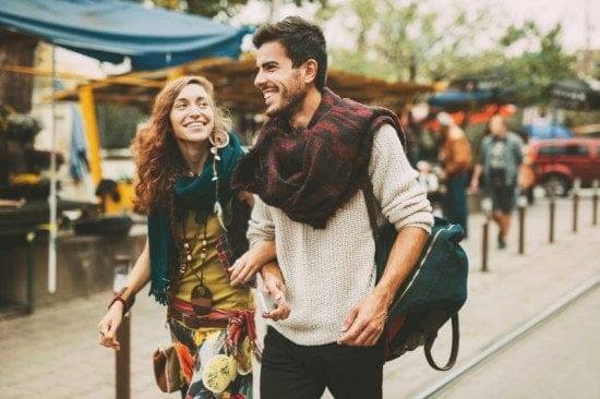 hippy couple walking through market