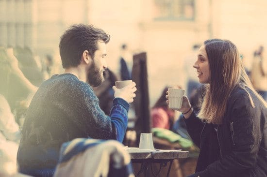 man and woman talking over coffee
