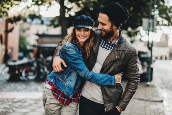 couple embracing while walking in city