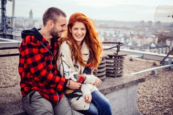happy couple embracing on rooftop