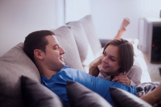 couple having conversation on couch