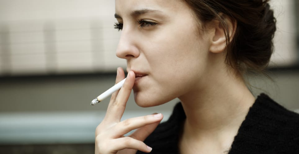 serious woman smoking cigarette