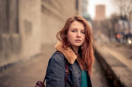 sad girl alone on city street