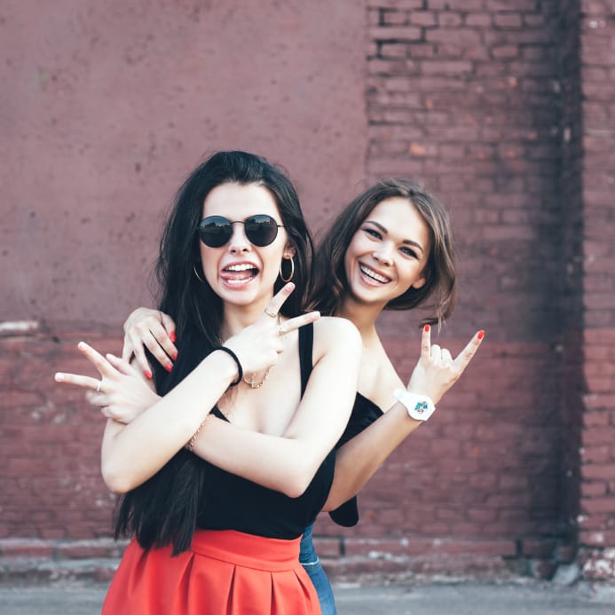 best friends making faces outdoors