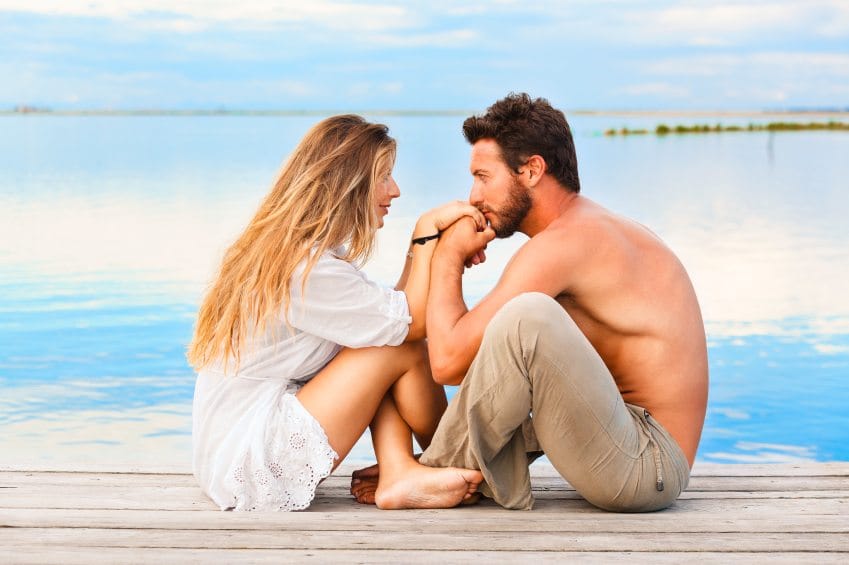 couple looking into each other's eyes by water