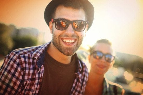 sunglasses couple smiling at camera