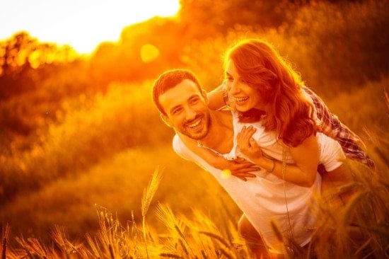 sunset couple in field