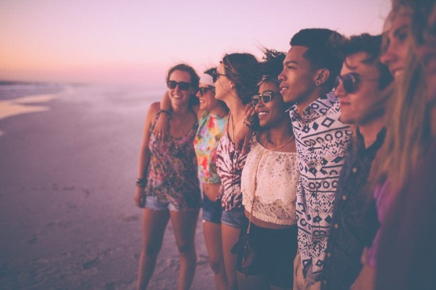 Friends on the beach at sunset.