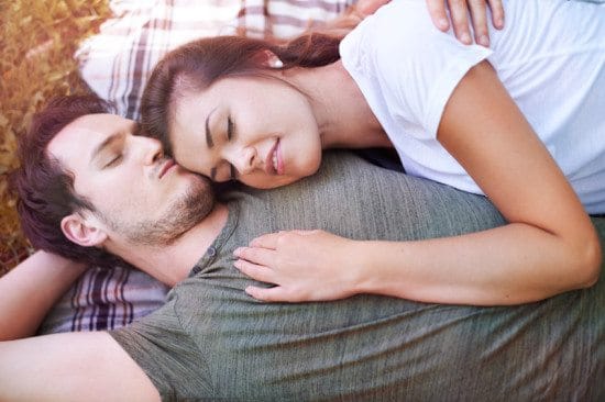 couple on picnic blanket cuddling