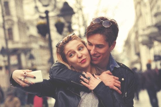 couple taking goofy city selfie