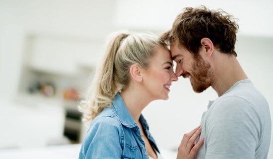 couple touching foreheads at home