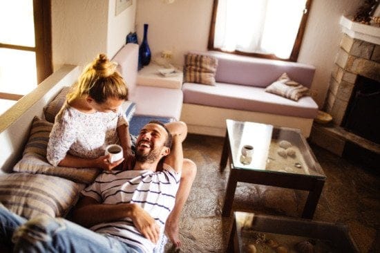 couple cuddling and laughing on couch