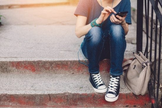 Woman's feet sitting on stairs.