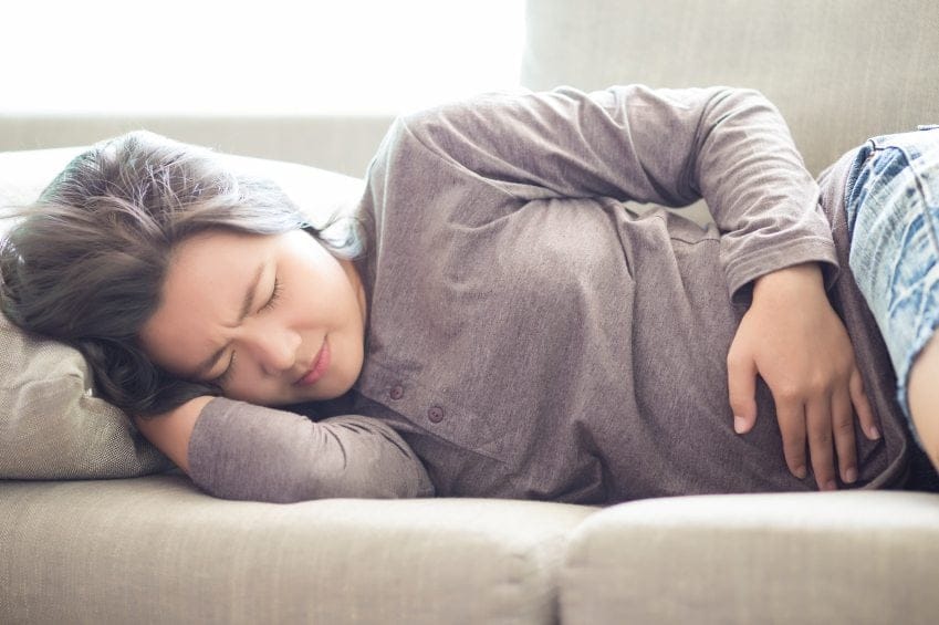 woman couch cramps