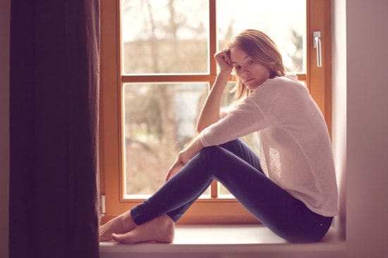 Woman sitting by window.