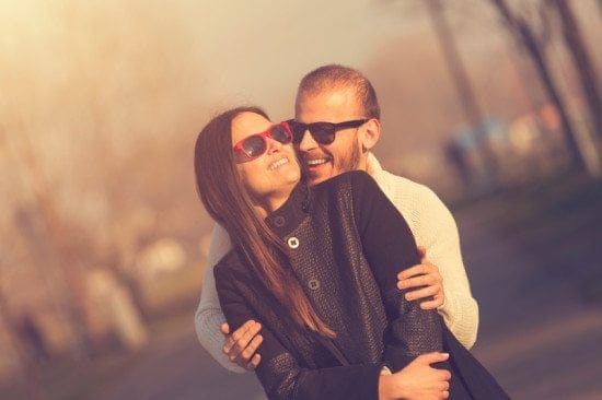 romantic couple hugging outside