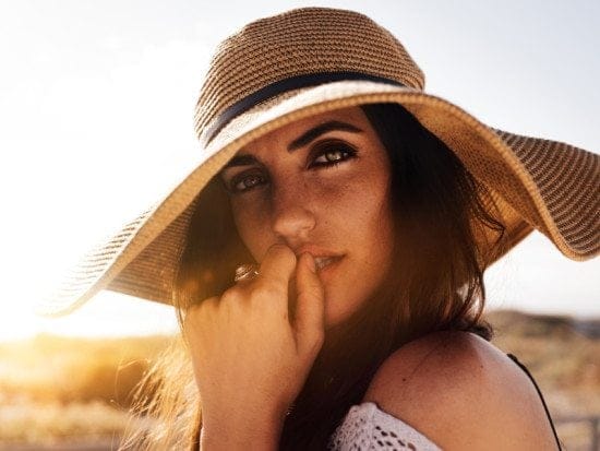 portait of serious woman in floppy hat