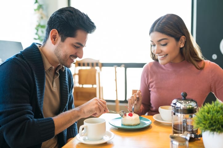 couple having dessert together in restaurant