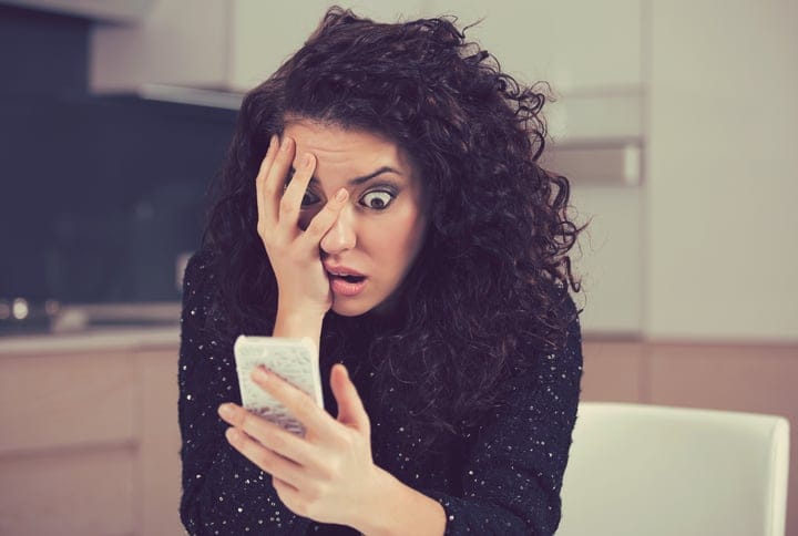 Woman on the phone with a surprised expression.