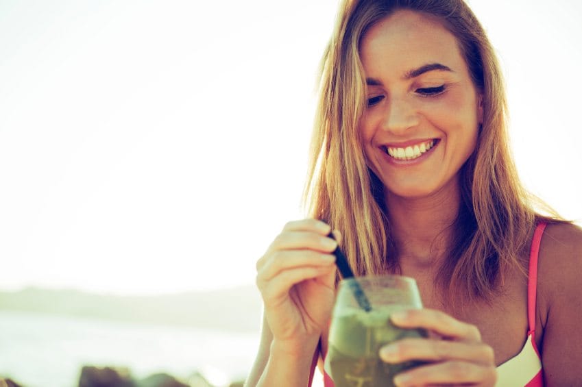 woman happy smoothie beach