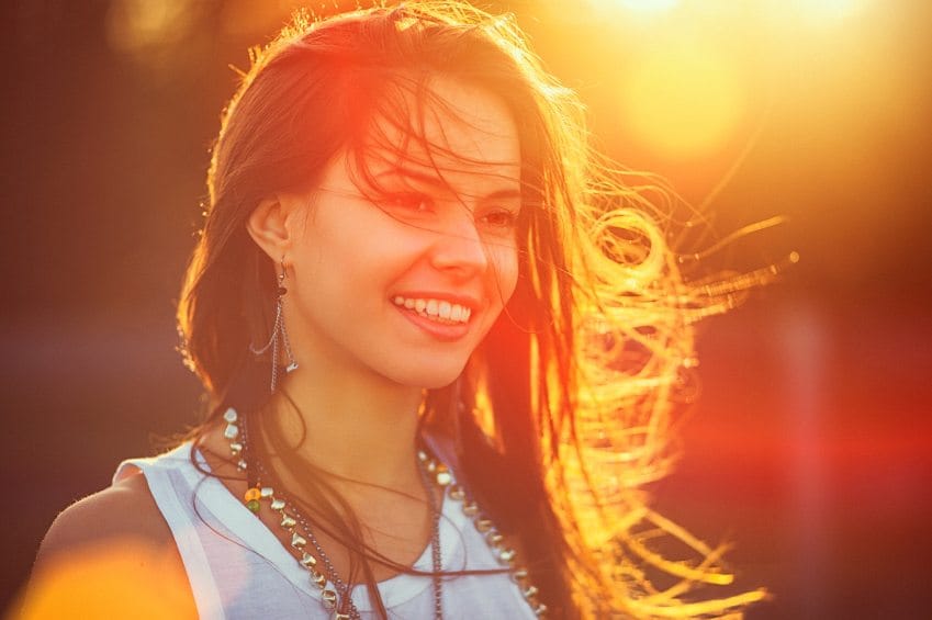 beautiful woman smiling at sunset