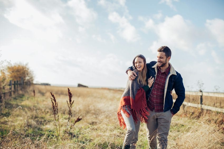 man woman romantic walk field