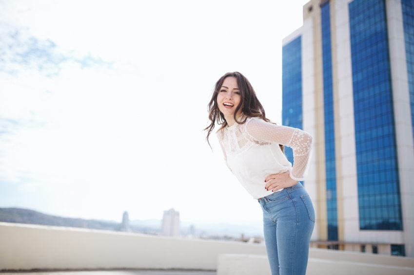 confident woman hands on hip sun